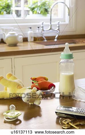 Stock Image - Baby Items on Counter Next to Cell Phone and Keys. Fotosearch