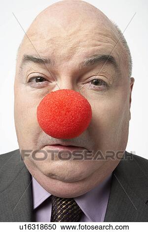Bald businessman Wearing Clown Nose, frowning, close-up View Large Photo Image Stock Image - Bald businessman Wearing Clown Nose, frowning, close-up. Fotosearch