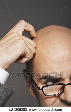 Bald businessman wearing glasses, scratching head, high section View Large Photo Image Stock Image - Bald businessman wearing glasses, scratching head, high section. Fotosearch