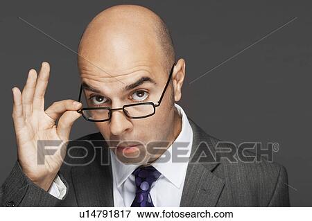 Balding man hand on glasses, making a face View Large Photo Image Stock Photo - Balding man hand on glasses, making a face. Fotosearch