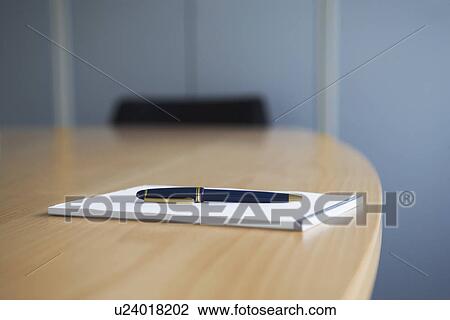 Ballpoint pen and notepad on conference table View Large Photo Image Stock Image - Ballpoint pen and notepad on conference table. Fotosearch
