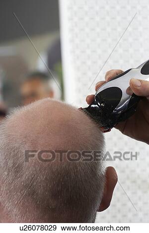 Barber shaving mans head in barber shop, close-up View Large Photo Image Stock Photo - Barber shaving mans head in barber shop, close-up. Fotosearch