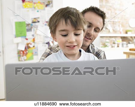 Boy (3-6) using laptop with father at home View Large Photo Image Stock Image - Boy (3-6) using laptop with father at home. Fotosearch