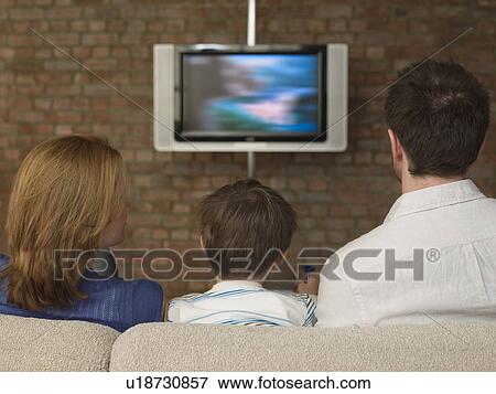 Boy Between Parents Watching Television View Large Photo Image Stock Photo - Boy Between Parents Watching Television. Fotosearch