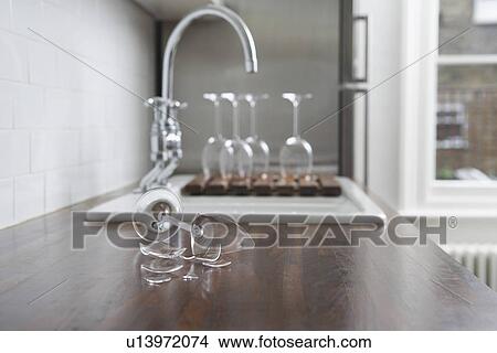 Picture - Broken wine glass on kitchen counter. Fotosearch