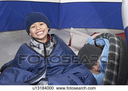 Brother and sister (7-12) relaxing in tent, (portrait) View Large Photo Image Stock Image - Brother and sister (7-12) relaxing in tent, (portrait). Fotosearch