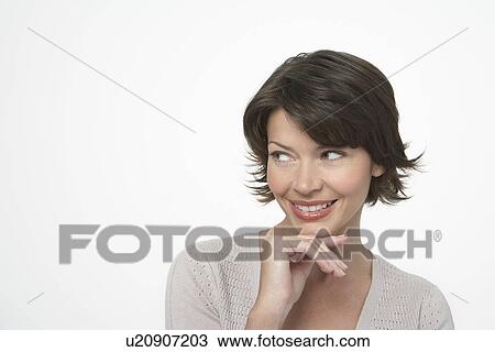 Brunette Woman looking to side, hand on chin View Large Photo Image Stock Image - Brunette Woman looking to side, hand on chin. Fotosearch