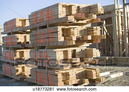 Stock Image - Building construction and Stacks of Planks. Fotosearch
