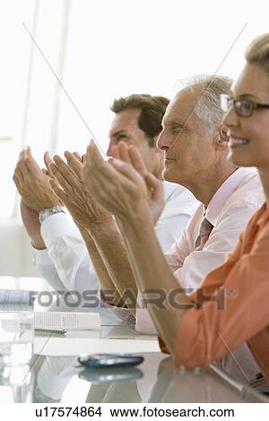 Picture - Business colleagues applauding in conference meeting. Fotosearch