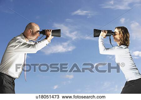 Business colleagues looking at each other through large binoculars outside, profile View Large Photo Image Stock Image - Business colleagues looking at each other through large binoculars outside, profile. Fotosearch