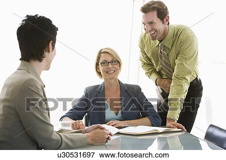 Business colleagues working in conference room View Large Photo Image Stock Photo - Business colleagues working in conference room. Fotosearch
