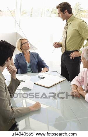 Business colleagues working in conference room View Large Photo Image Stock Photography - Business colleagues working in conference room. Fotosearch