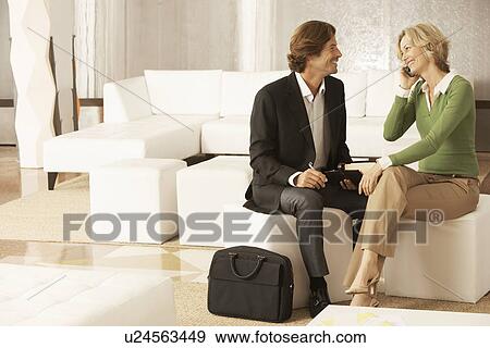 Business couple in living room View Large Photo Image Stock Photo - Business couple in living room. Fotosearch