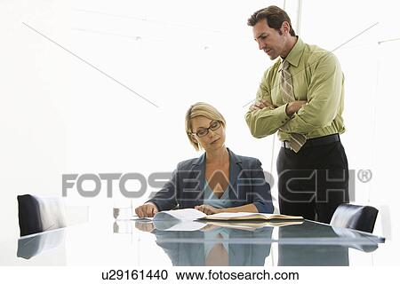 Business man and woman working in conference room View Large Photo Image Stock Image - Business man and woman working in conference room. Fotosearch