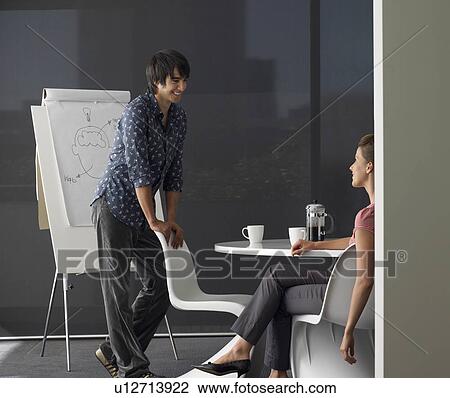 Stock Image - Business man giving presentation on flipchart. Fotosearch