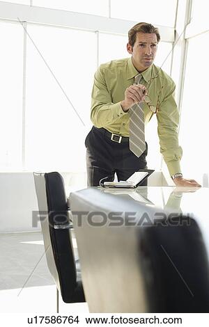 Picture - Business man in conference room. Fotosearch