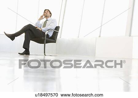 Business man sitting in empty room View Large Photo Image Stock Image - Business man sitting in empty room. Fotosearch