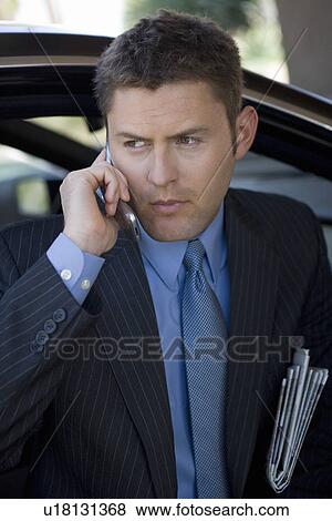 Business man using mobile phone View Large Photo Image Stock Photo - Business man using mobile phone. Fotosearch