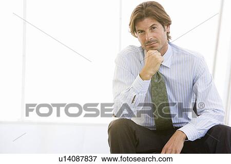 Business man with hand on chin, portrait View Large Photo Image Stock Photo - Business man with hand on chin, portrait. Fotosearch