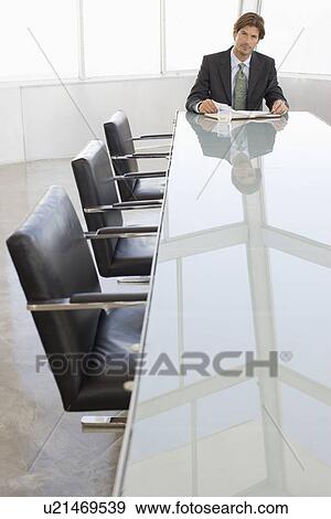 Stock Photo - Business man working in conference room. Fotosearch