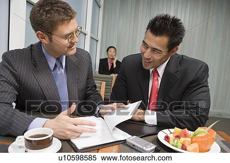 Stock Photography - Business people having meeting and lunch. Fotosearch