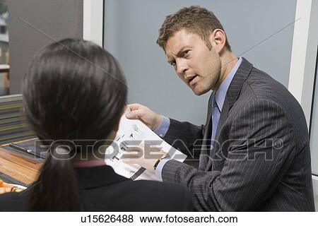Stock Photo - Business people having meeting. Fotosearch