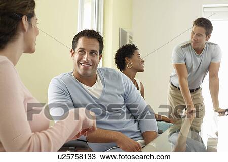 Stock Image - Business people in office meeting. Fotosearch
