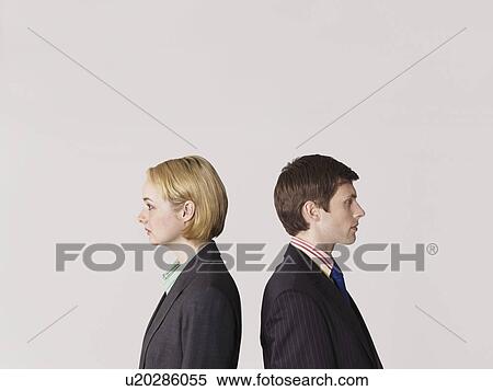 Stock Photography - Business people standing back to back, on white background. Fotosearch