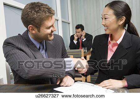 Businessman and woman shaking hands View Large Photo Image Stock Photo - Businessman and woman shaking hands. Fotosearch