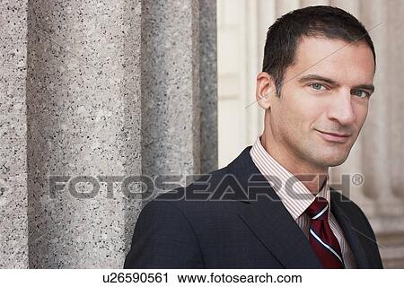 Businessman by outdoor column, portrait View Large Photo Image Stock Image - Businessman by outdoor column, portrait. Fotosearch