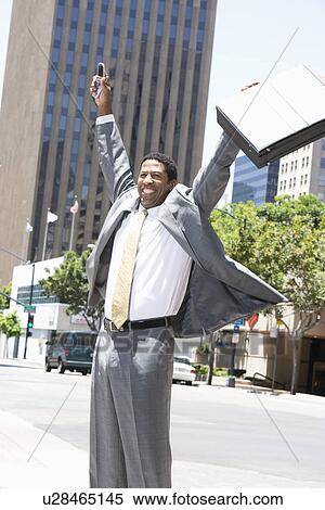 Stock Photography - Businessman celebrating at street. Fotosearch
