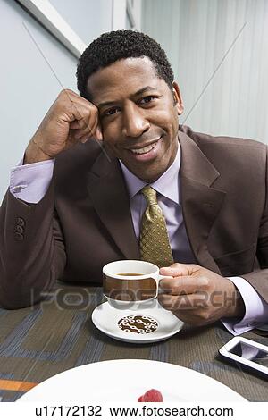 Businessman drinking coffee on business lunch View Large Photo Image Stock Image - Businessman drinking coffee on business lunch. Fotosearch