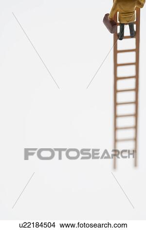 Businessman figurine climbing ladder, low section View Large Photo Image Picture - Businessman figurine climbing ladder, low section. Fotosearch