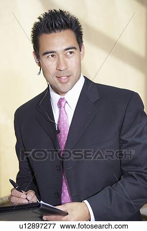 Stock Photo - Businessman holding file on blue tooth, half-length. Fotosearch