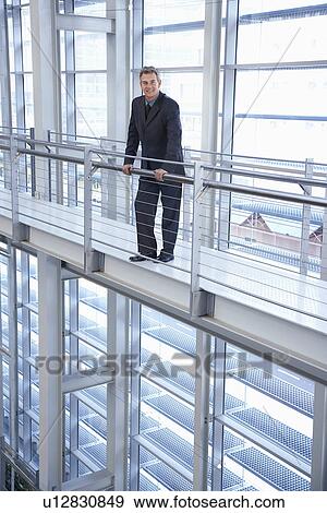 Stock Photo - Businessman in modern building, portrait. Fotosearch