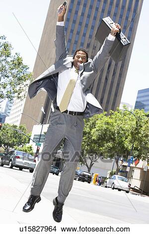 Businessman jumping at street View Large Photo Image Picture - Businessman jumping at street. Fotosearch