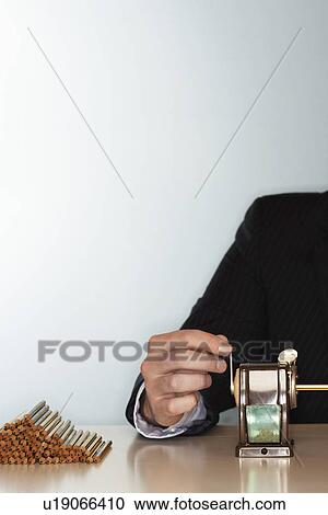 Businessman sharpening pencils at desk, mid section View Large Photo Image Stock Image - Businessman sharpening pencils at desk, mid section. Fotosearch