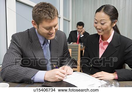 Businessman signing agreement on lunch View Large Photo Image Picture - Businessman signing agreement on lunch. Fotosearch