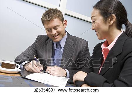 Businessman signing agreement on lunch View Large Photo Image Stock Photo - Businessman signing agreement on lunch. Fotosearch