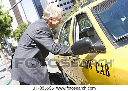 Businessman talking to taxi driver View Large Photo Image Stock Photography - Businessman talking to taxi driver. Fotosearch