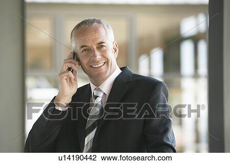Stock Image - Businessman Using Cell Phone. Fotosearch