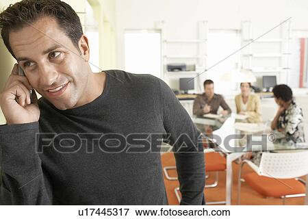 Businessman using mobile phone in office View Large Photo Image Stock Photo - Businessman using mobile phone in office. Fotosearch