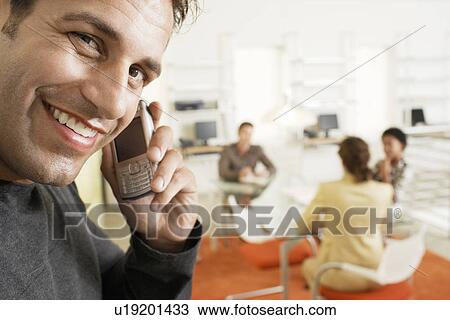 Businessman using mobile phone in office, portrait View Large Photo Image Stock Image - Businessman using mobile phone in office, portrait. Fotosearch