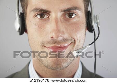 Stock Photograph - Businessman Wearing Telephone Headset. Fotosearch