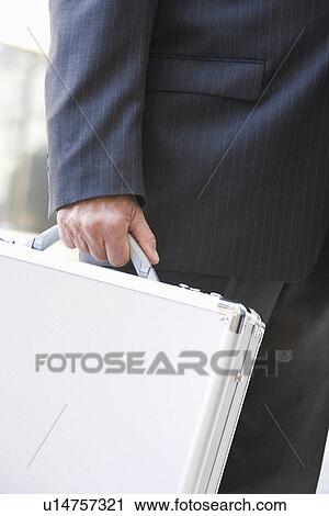 Businessman with briefcase, mid section View Large Photo Image Stock Image - Businessman with briefcase, mid section. Fotosearch