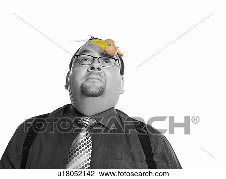 Stock Image - Businessman with Egg on his Face. Fotosearch