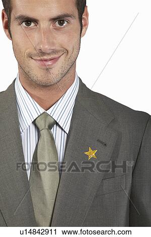 Stock Image - Businessman with gold star on suit, portrait. Fotosearch