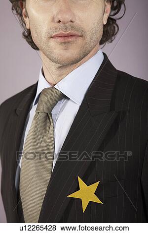 Stock Photo - Businessman with gold star on suit, portrait. Fotosearch