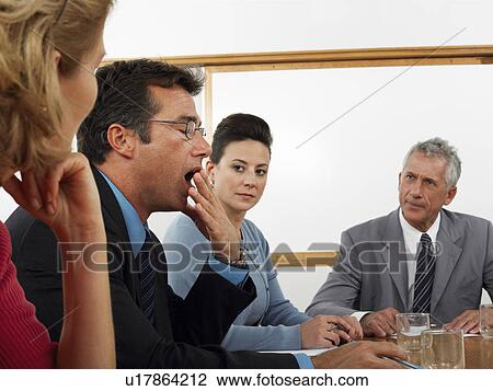 Businessman yawning in conference meeting View Large Photo Image Stock Image - Businessman yawning in conference meeting. Fotosearch