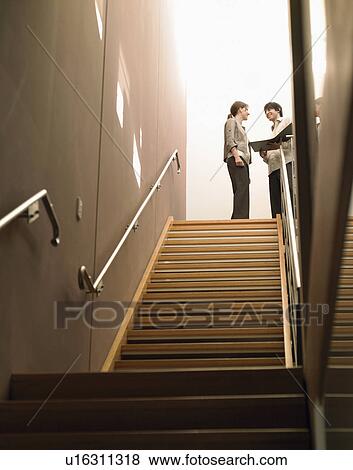 Stock Photo - Businesspeople at Top of Stairs. Fotosearch
